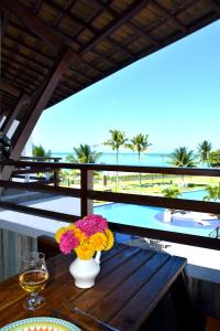 塔曼达雷Flat Maui Beach- Com vista e de frente para o mar的阳台上的花瓶桌子