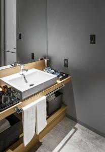 札幌ALPHABED INN Sapporo Odori Park的浴室配有盥洗盆和带毛巾的台面。