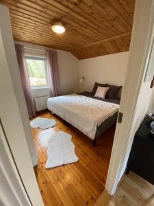 哥德堡Björsjödal Lake House's的一间卧室设有一张床和木制天花板
