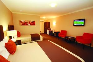 怀阿拉桑丹莫特酒店的酒店客房设有两张床和一台平面电视。