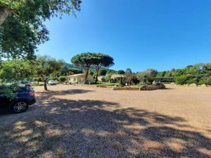 维琪奥港Les Jardins De Santa Giulia - Charmante chambre d'hôte的停在一个有树的停车场的汽车