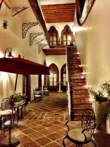 克雷塔罗艾尔斯拉弗恩精品酒店的一座带椅子和遮阳伞的楼梯的建筑