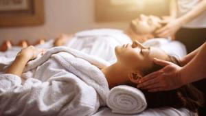 奥尔比亚WALLURE - Tickled Hotel & Wellness的躺在毛巾下床上的妇女