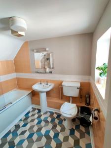 海斯天鹅酒店的浴室配有卫生间、盥洗盆和浴缸。