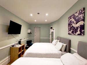 海斯天鹅酒店的一间酒店客房,设有两张床和电视