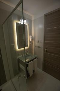 科尔多瓦ÑU Posta Urbana Hotel Boutique的一间带水槽、镜子和淋浴的浴室