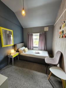 埃尔斯米尔港87号客房旅馆的小房间设有床和窗户