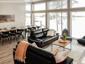 KarjalaisenniemiHoliday Home Villa kallas by Interhome的客厅配有黑色皮革家具和桌子
