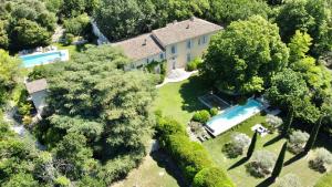 普罗旺斯艾克斯La Bastide de Ganay的享有带游泳池和树木的房屋的空中景致