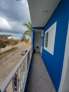 圣托梅-达斯莱特拉斯Apartamento avenida 07的阳台设有蓝色的墙壁,享有海滩美景。