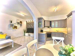 塞格德Mirell Apartman的开放式厨房以及带桌椅的客厅。