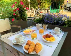 尼斯博雷阿酒店的早餐桌包括羊角面包、炒鸡蛋和橙汁