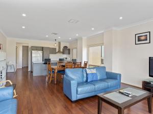 诺曼维尔26 45 St Andrews Boulevard的客厅配有蓝色的沙发和桌子