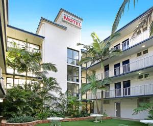卧龙岗游艇码头汽车旅馆的一座楼前有棕榈树的酒店