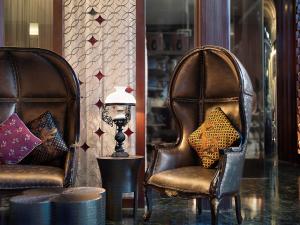 梭罗The Royal Surakarta Heritage - Handwritten Collection的两个皮椅和一个灯在房间里