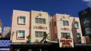 圣胡安波多黎各梦想酒店的粉红色的建筑,旁边标有标志