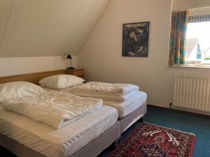 Hello Zeeland - Vakantiehuis Stern 188客房内的一张或多张床位