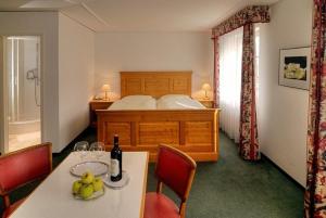 瓦伦施塔特丘坲斯坦酒店的一间卧室配有一张床和一张带水果的桌子