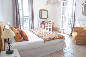 比兹米内瓦Logis hôtel et restaurant La Bastide Cabezac的一间卧室配有一张床、一张桌子和一面镜子
