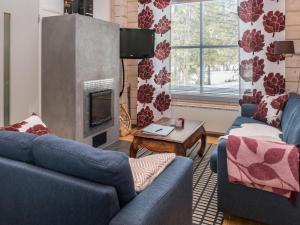 鲁卡Holiday Home Villa hanki by Interhome的客厅配有2张蓝色沙发和壁炉