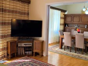 雅典HIGH QUALITY 110qm 2BR at Simos-Lux-Apartment的客厅配有电视和桌椅