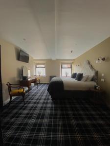 彭里斯酒廊酒店&酒吧 的一间卧室配有一张大床和一张书桌