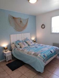 雅尔河畔圣万康彼岸完美旅馆的一间卧室配有一张带蓝色墙壁的大床