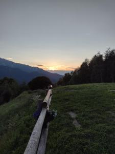 Chiusa di PesioRifugio Alpino Baudinet - Trek&Relax的地面上的木栅,背面是日落