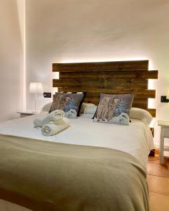 巴鲁尔拉阿塔蒙坦亚酒店的一间卧室配有一张大床和木制床头板
