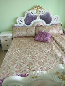 埃勒尼特Апартаменты Талиана Бич курорта Елените的一张带白色床头板和紫色枕头的床