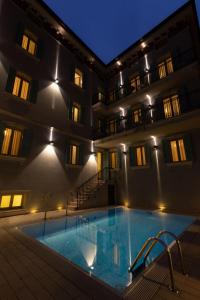 加尔多内-里维耶拉Mefuta Hotel的一座游泳池,在晚上在建筑物前