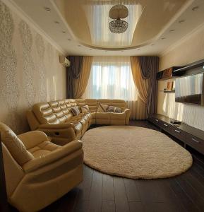 基辅Просторные апартаменты的带沙发和地毯的大型客厅