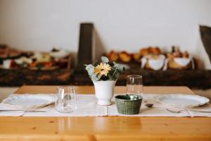 法萨诺马塞里亚加拉帕乡村民宿的一张桌子,上面有两盘盘,花瓶