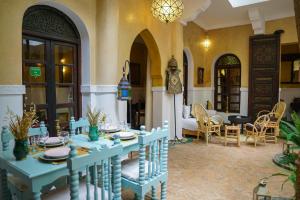 马拉喀什Riad Dama & Spa的客厅配有蓝色的桌椅
