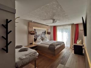 萨尔察赫河畔戈灵阿德勒尔酒店的一间卧室设有两张床和窗户。