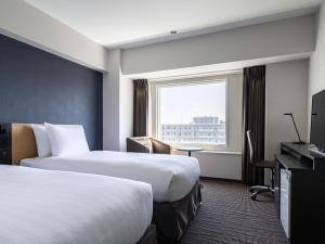 札幌札幌全日空皇冠假日酒店的酒店客房设有两张床和窗户。