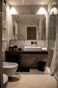 锡拉库扎Palazzo Salomone的一间带水槽、卫生间和镜子的浴室