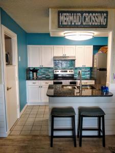 阿兰瑟斯港Vista del Mar 505BH的厨房配有水槽和带凳子的台面