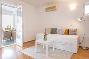 巴什卡沃达Apartmani Grmoja的白色的客厅配有白色的沙发和桌子