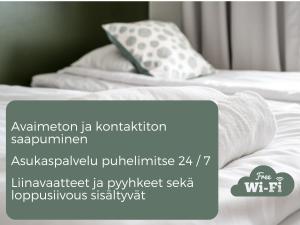 LohjaHiisi Hotel Lohja的一张带白色床单和枕头的床的照片