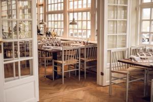 瓦尔德Arnbjerg Pavillonen的一间带桌椅和窗户的用餐室