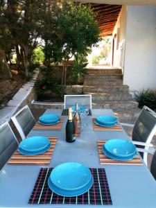圣安东尼奥湾Sera de Vall的一张桌子上放着蓝色的盘子和葡萄酒瓶