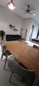 雪邦CozyStay @ Core SoHo Suite KLIA的客厅配有木桌和椅子
