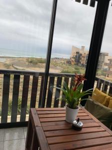 拉卡诺奥肯Appartement vue sur mer, 30m de la plage的海景阳台上的桌子