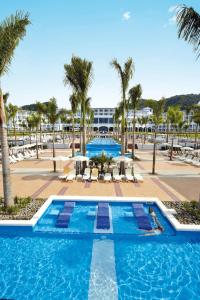 科克Riu Palace Costa Rica - All Inclusive的棕榈树游泳池及度假村