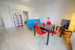 苏黎世希特斯托法彻出租公寓的一间用餐室,配有黑桌子和红色椅子