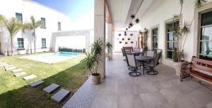 MatamorosHOTEL PLAZA MATAMOROS的一个带桌子的庭院和一个带游泳池的庭院
