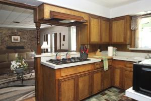 克恩维尔Kern Riverview Inn的厨房配有木制橱柜和炉灶烤箱。