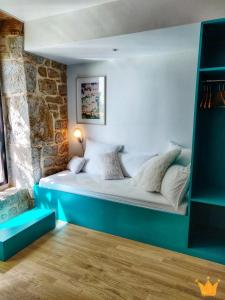 SarrazacEstafête的石墙客房的卧室配有一张床