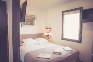 卡尔卡松514公寓酒店的一间卧室配有一张床,上面有两条毛巾